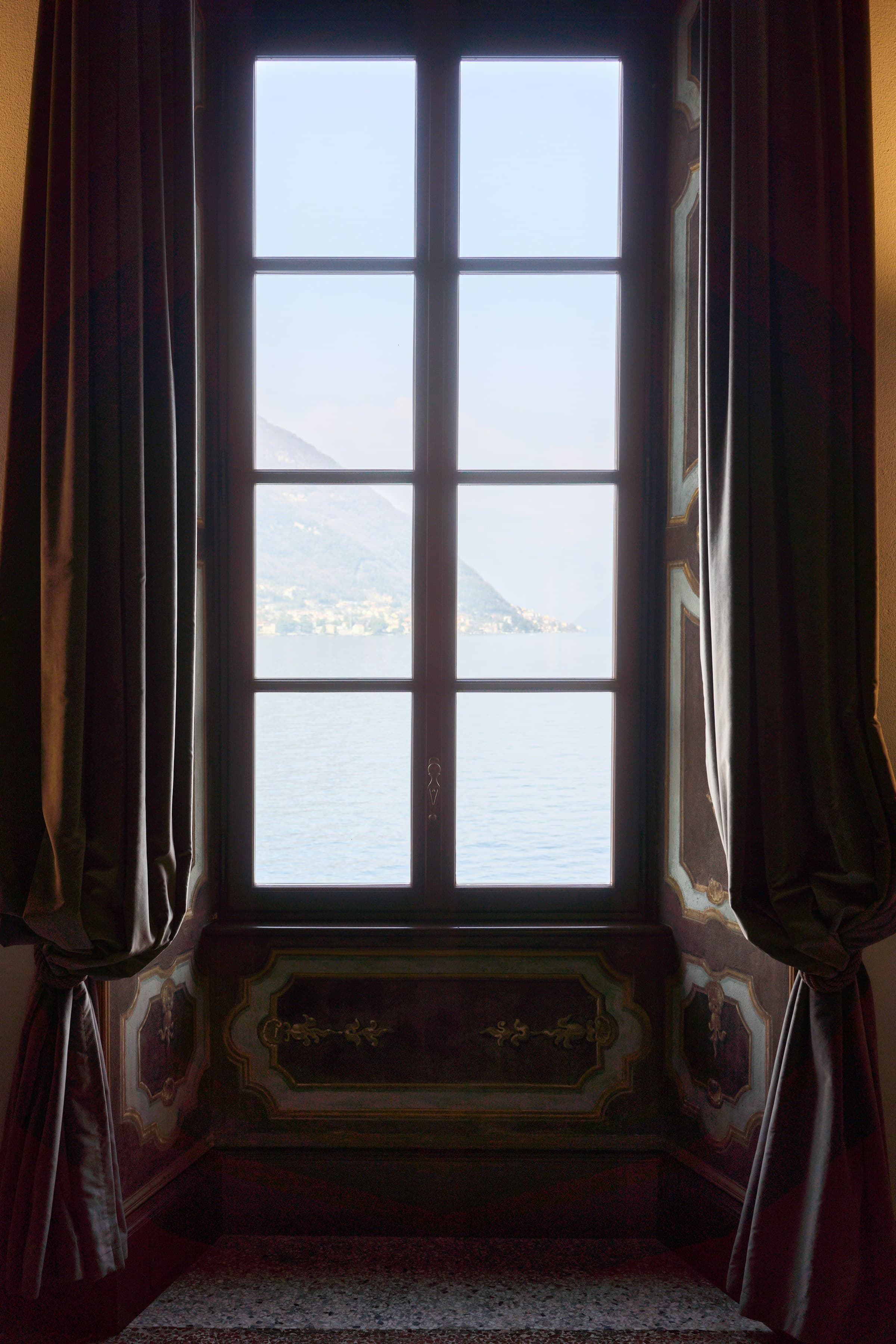 Window view of Lake Como from inside an Italian villa